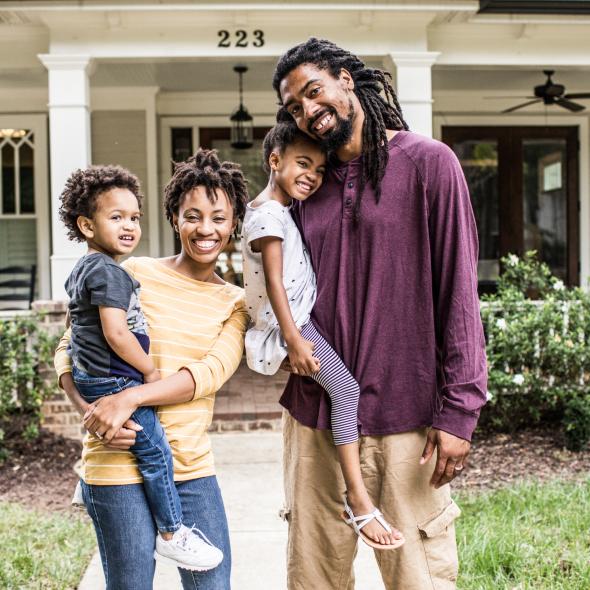 Happy Black Family in front of house