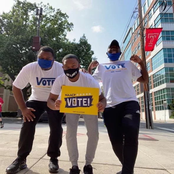 NAACP Members holding VOTE sign