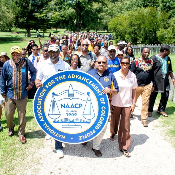 NAACP Leadership at march holding NAACP seal