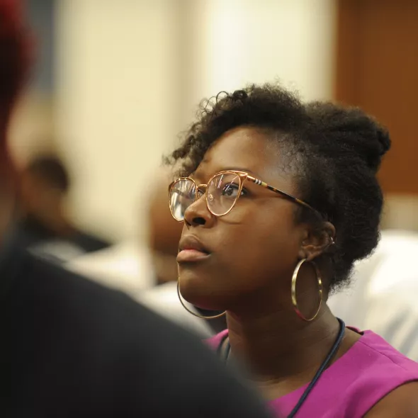 Woman listening intently at meeting