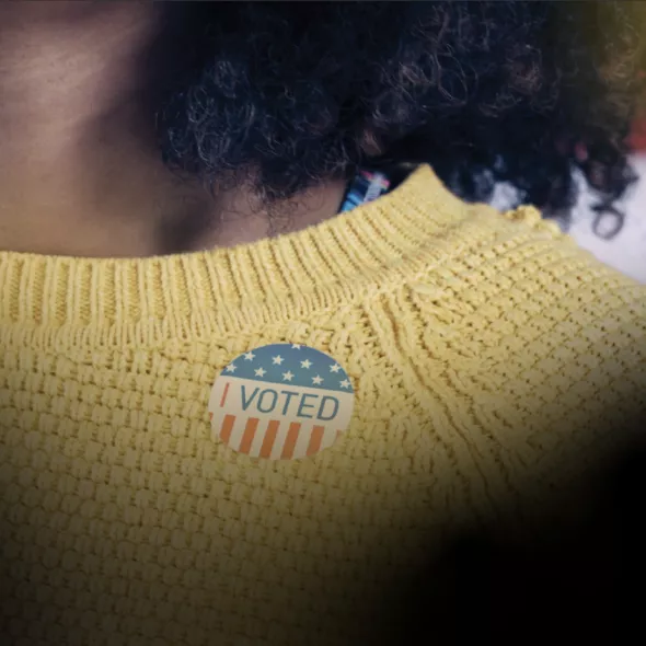 Black Voter Day Hero - Black woman wearing I Voted Sticker