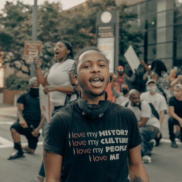 Young Black Male - Outdoors - in protest or rally - speaking