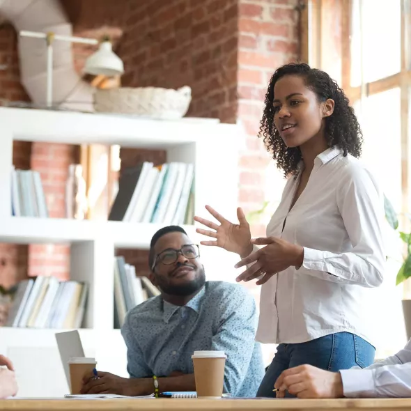 Young Black Female Speaking in Meeting