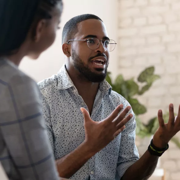 Black Man Talking with Group - Inside