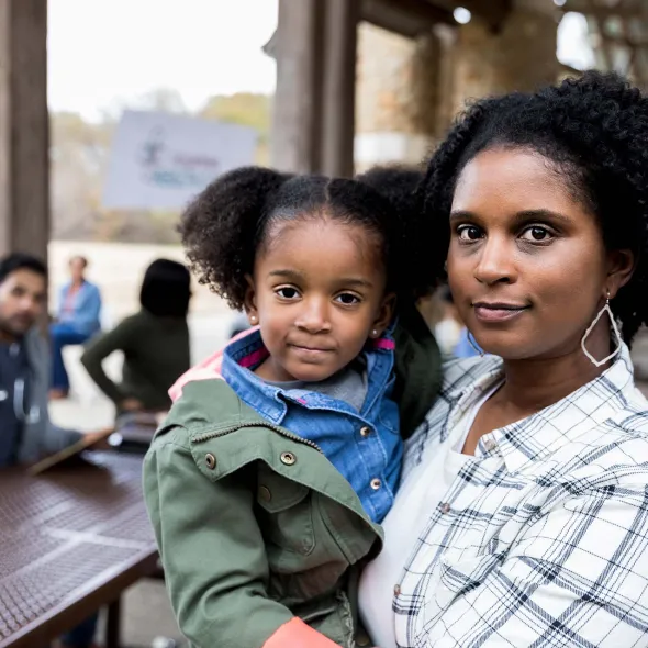 Black Female holding Toddler - Outdoors