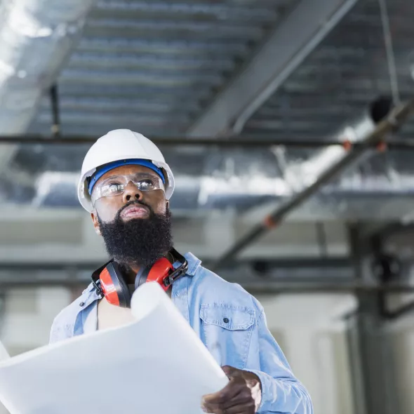 Construction Worker Reviewing Blueprints