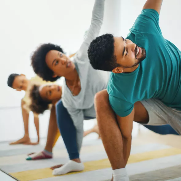 Family Doing Yoga Together Indoors