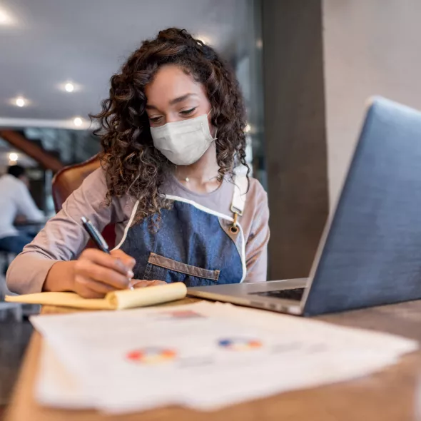 Masked Girl Studying with Computer and Notes - Inside