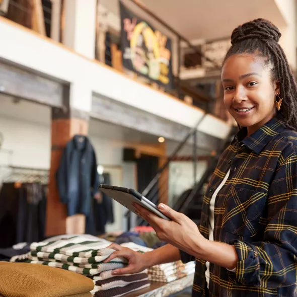 Black Female - Solo - in retail setting - smiling