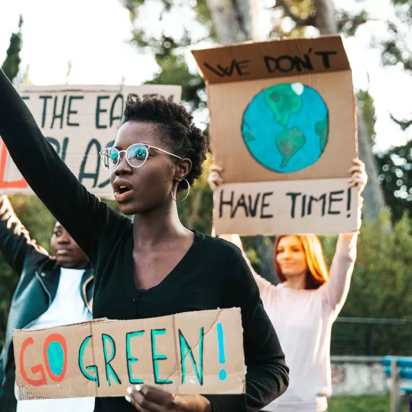 Young Adults Protesting - Holding Signs About the Environment