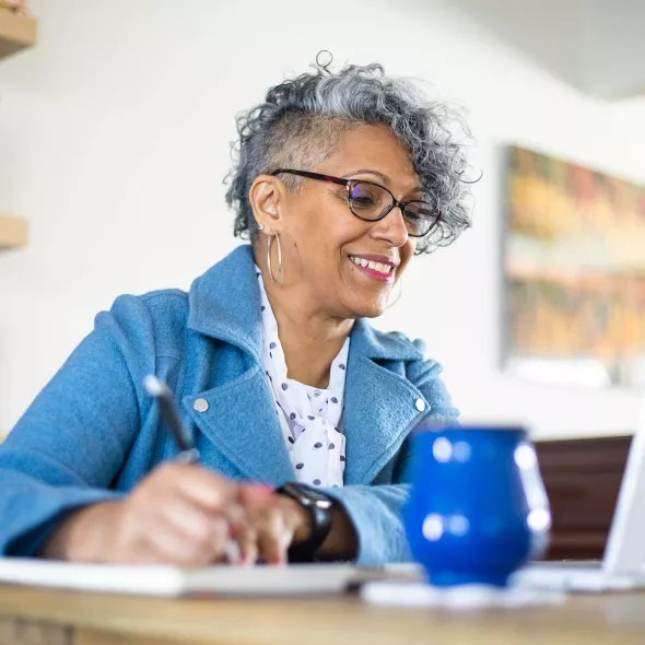 Woman Looking at Laptop Screen - Solo - Smiling