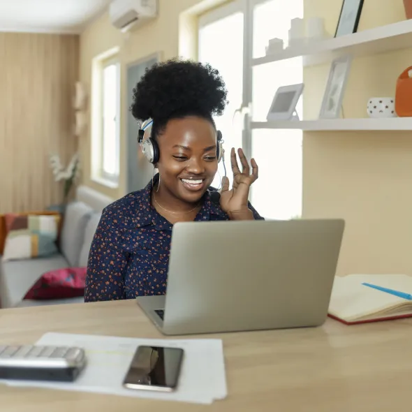 Black Woman Wearing Headphones with Laptop - Indoors