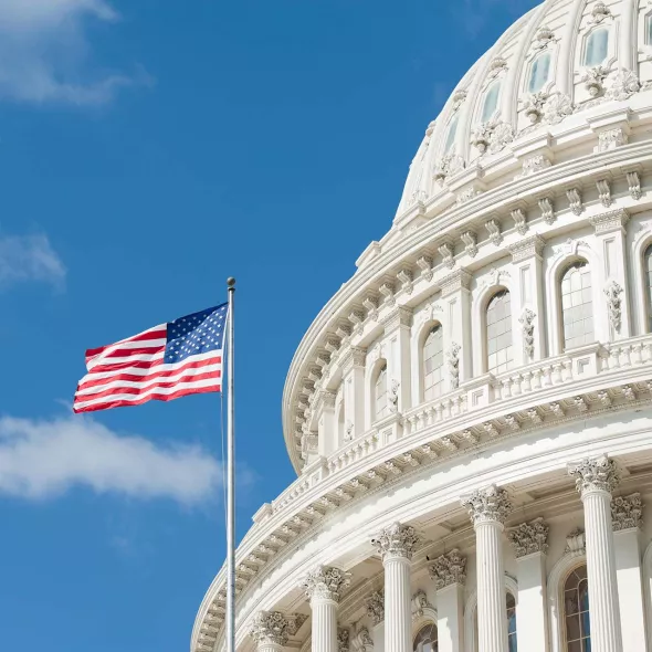 Close-up - The U.S. Capitol Building with American Flag - Daylight