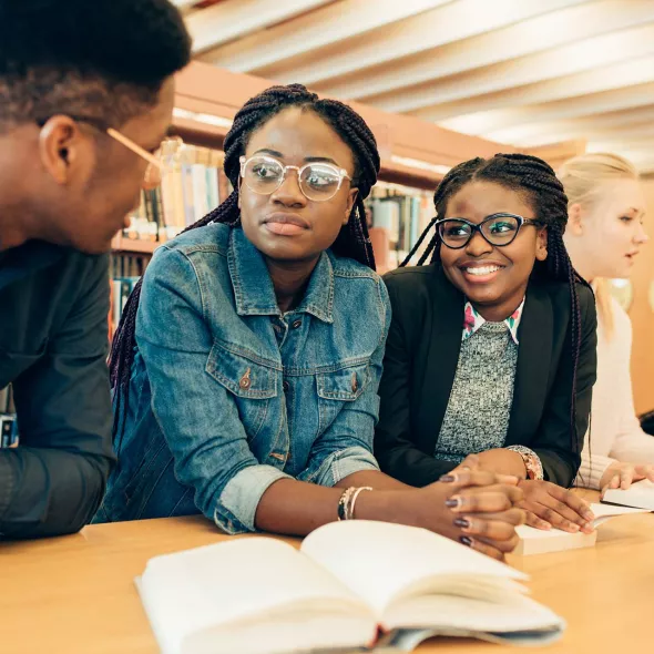 Three Black Young Adults in a Library