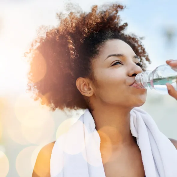 Close-up of Exercising Woman Drinking Water