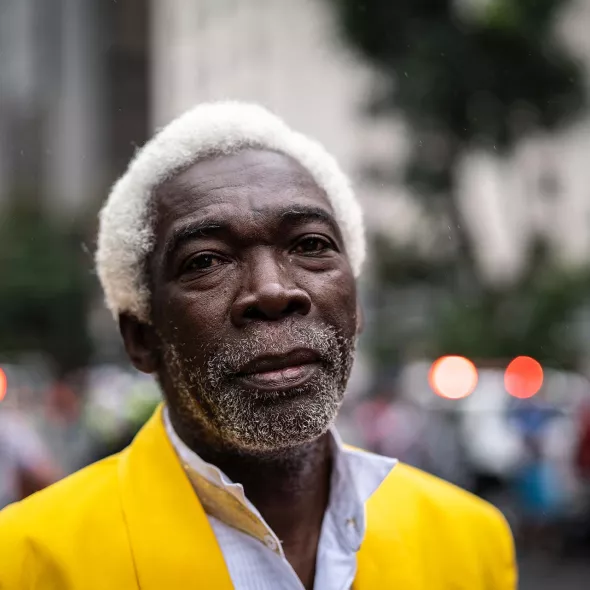 Close-up - Black Male in Front of Blurred Cityscape