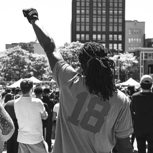 Black Male - fist raised - at protest or rally
