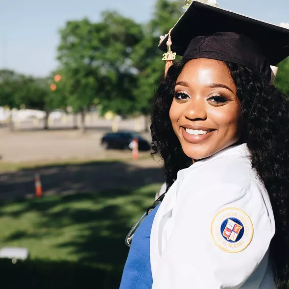 Close-up Young Black Female - Solo - in graduation cap - smiling