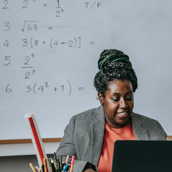 Black Female Teacher - classroom setting