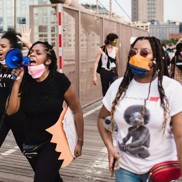 Group at rally or protest - females in forefront - with bullhorn