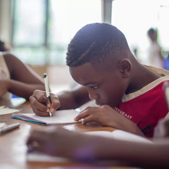 Young Black Children Doing Homework Together at Table