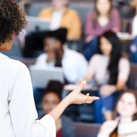 Blurred View of Teacher Instructing a Class of Students