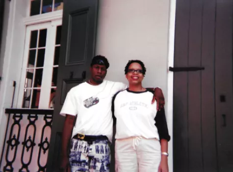 Airis Freeman and her brother pose for a photo in front of a beige building in the French Quarter of New Orleans.