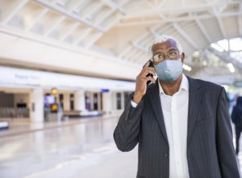 Man Walking in Airport with Mask - COVID