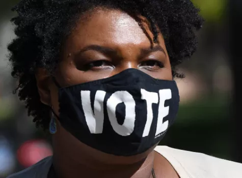 Close-up - Stacey Abrams wearing vote face mask