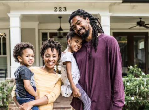 Happy Black Family outside of house