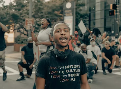 Young Black Male - Outdoors - in protest or rally - speaking