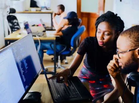 Black Male and Female - in Classroom setting - collaborating - on computer