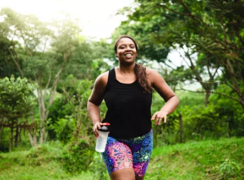 Smiling Black Woman Exercising Outside in the Summertime