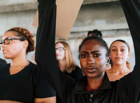 Young Black Female in Group Holding Sign in Protest