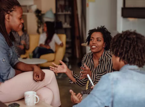 Young Black Female in Casual Group - Speaking