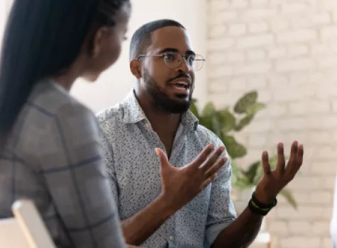 Black Man Talking with Group - Inside