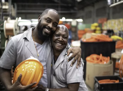 Happy Construction Coworkers Sharing a Hug