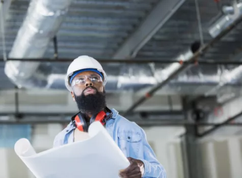 Construction Worker Reviewing Blueprints