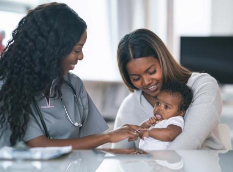 Black Female holding Baby - with Nurse