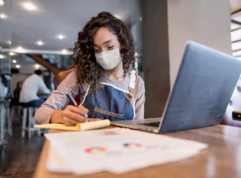 Masked Girl Studying with Computer and Notes - Inside