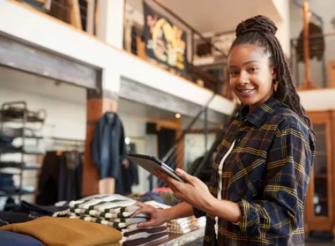 Black Female - Solo - in retail setting - smiling