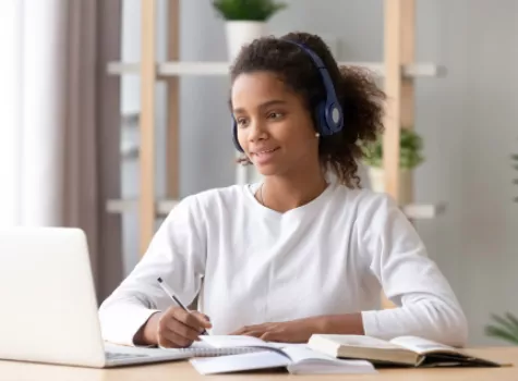 Young Black Girl with Headset Taking an Online Class