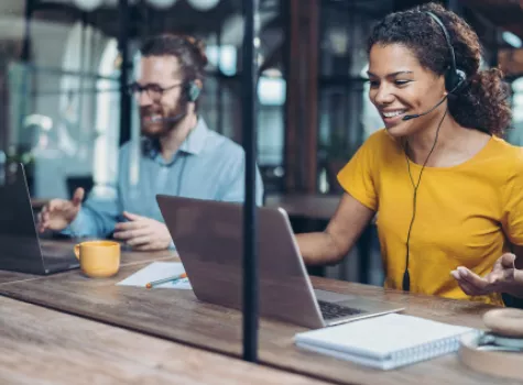 Smiling People Working with Headsets and Laptops - Inside