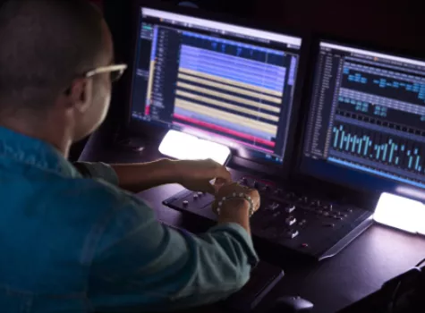 Producer with Computer and Sound Equipment in Studio