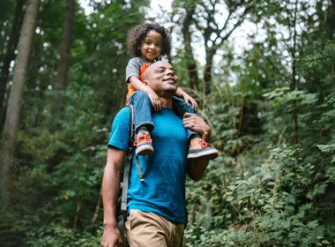 Black Male with Child on His Shoulders - Outside