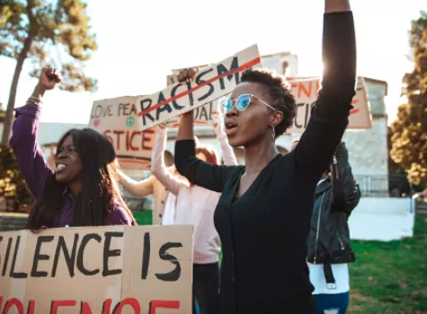 Young Adults Protesting - Holding Signs