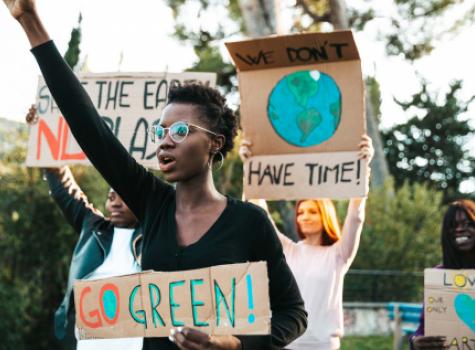 Young Adults Protesting - Holding Signs About the Environment