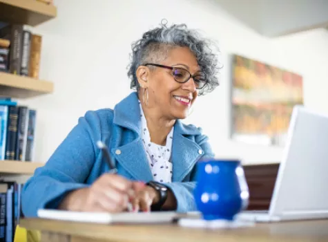 Woman Looking at Laptop Screen - Solo - Smiling