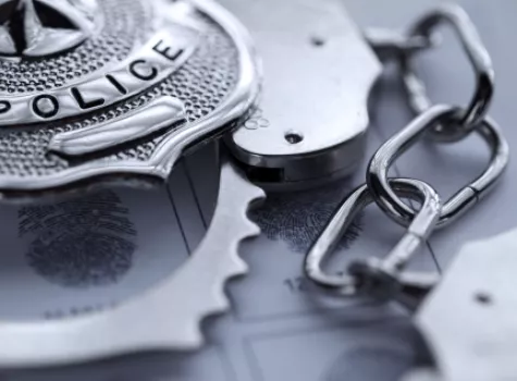 Close-up of Police Badge and Handcuffs