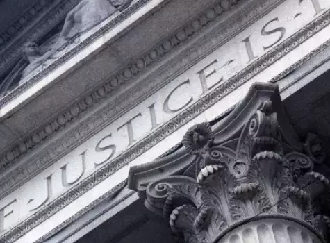 The Word Justice Carved into Architecture of Marble Courthouse